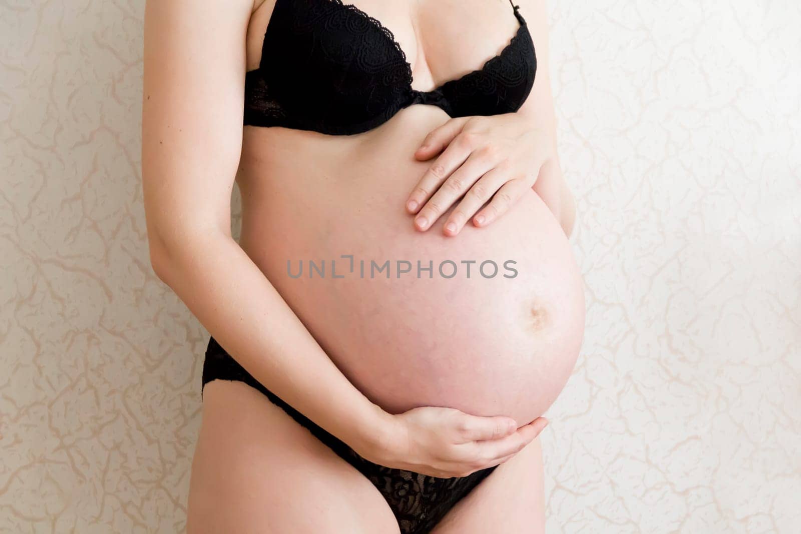 Image of pregnant woman in black underwear