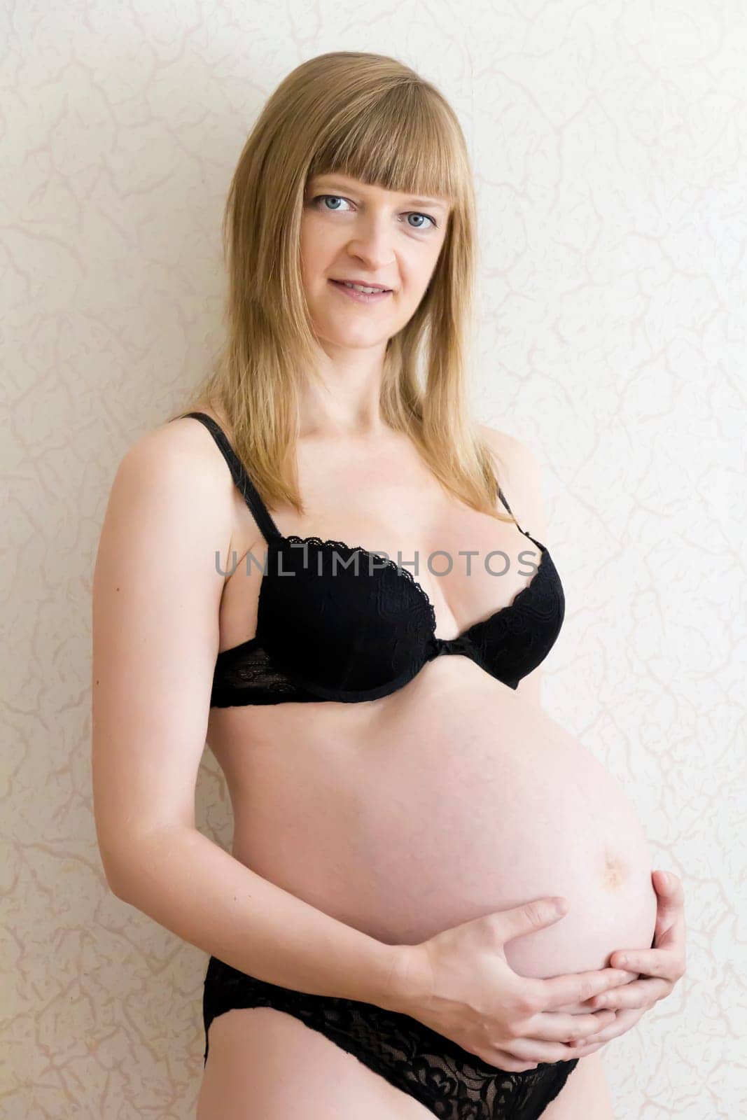Image of pregnant woman in black underwear
