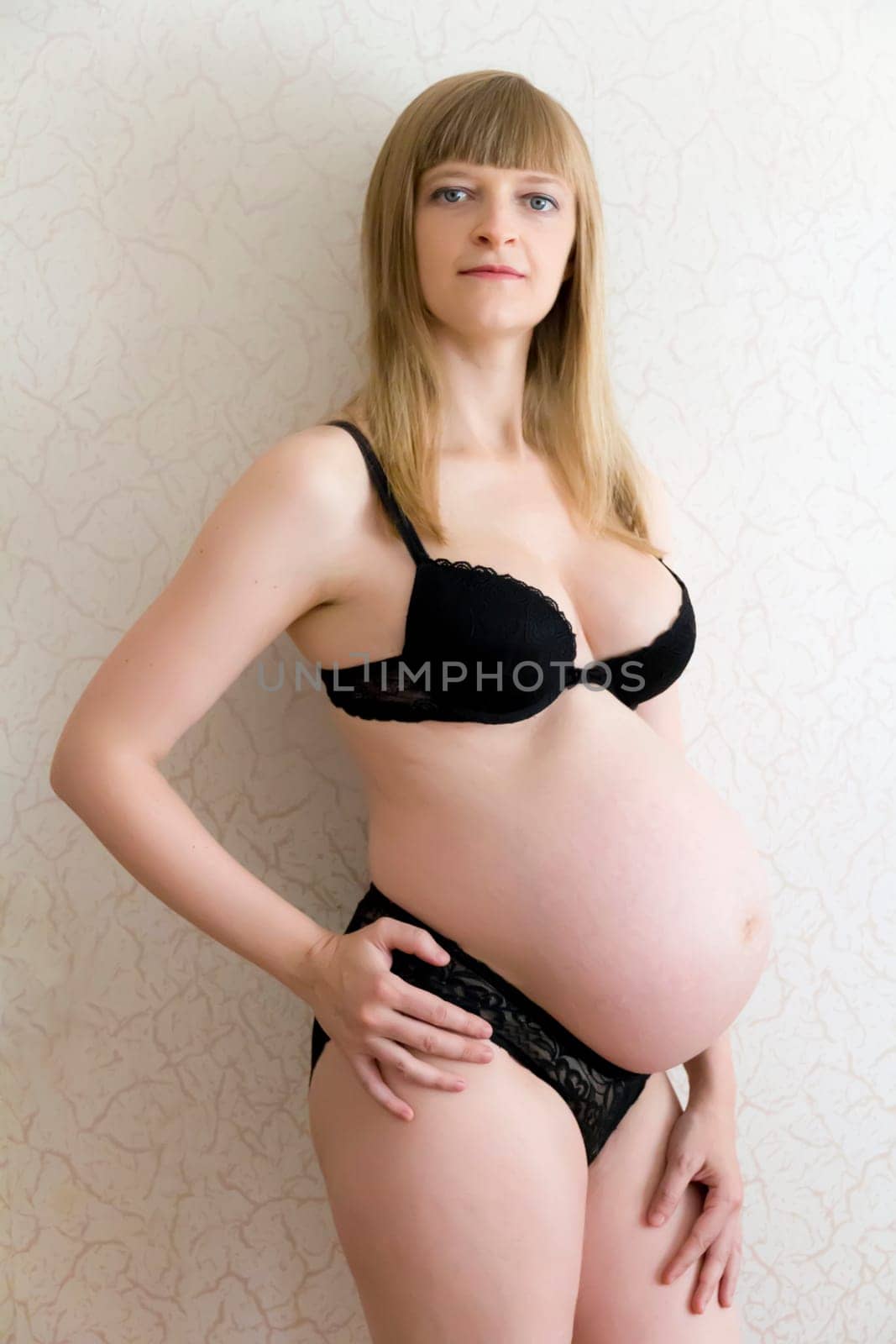 Image of pregnant woman in black underwear