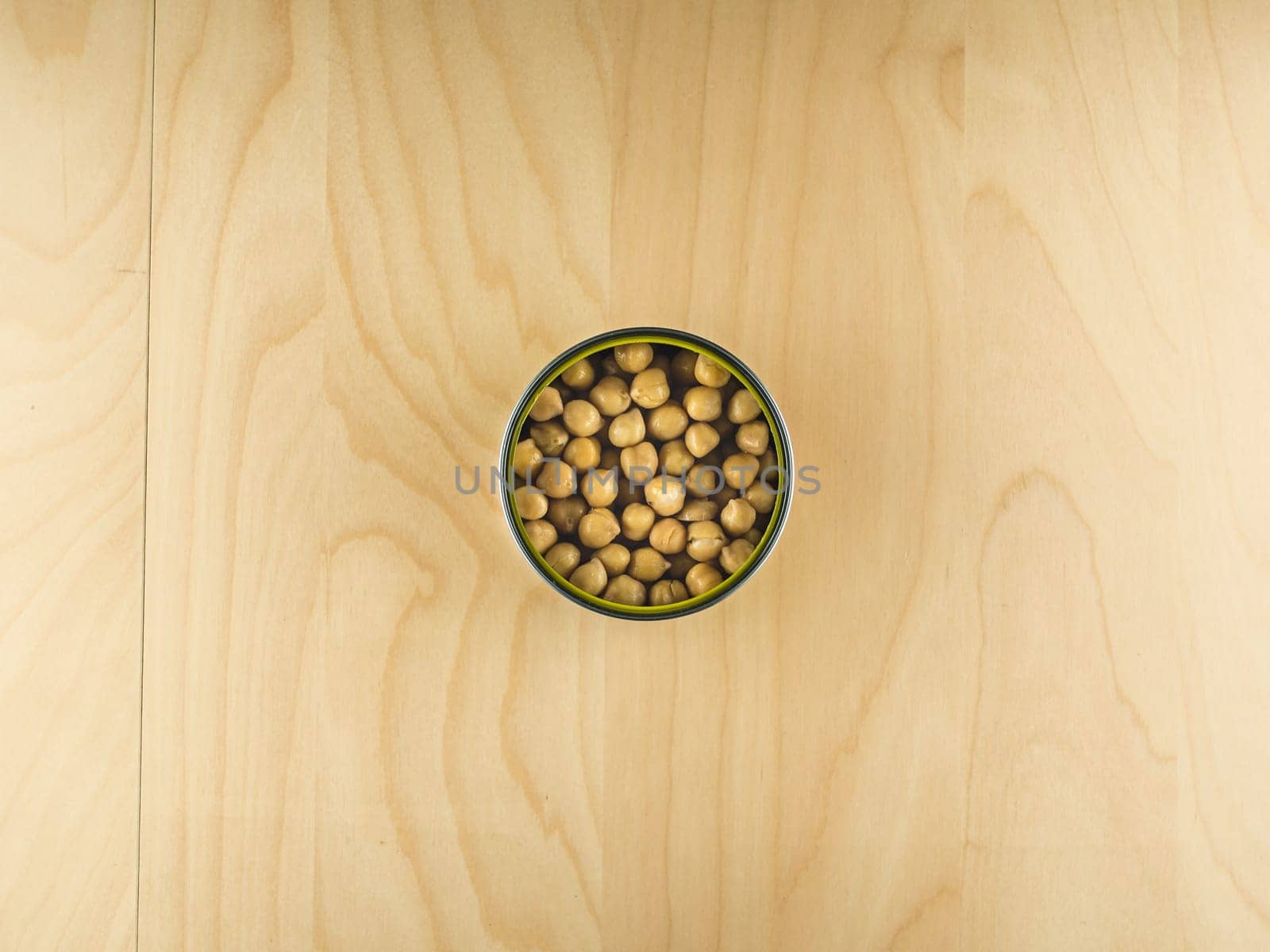 Top view of open tin can with chickpeas, simple dieting illustration