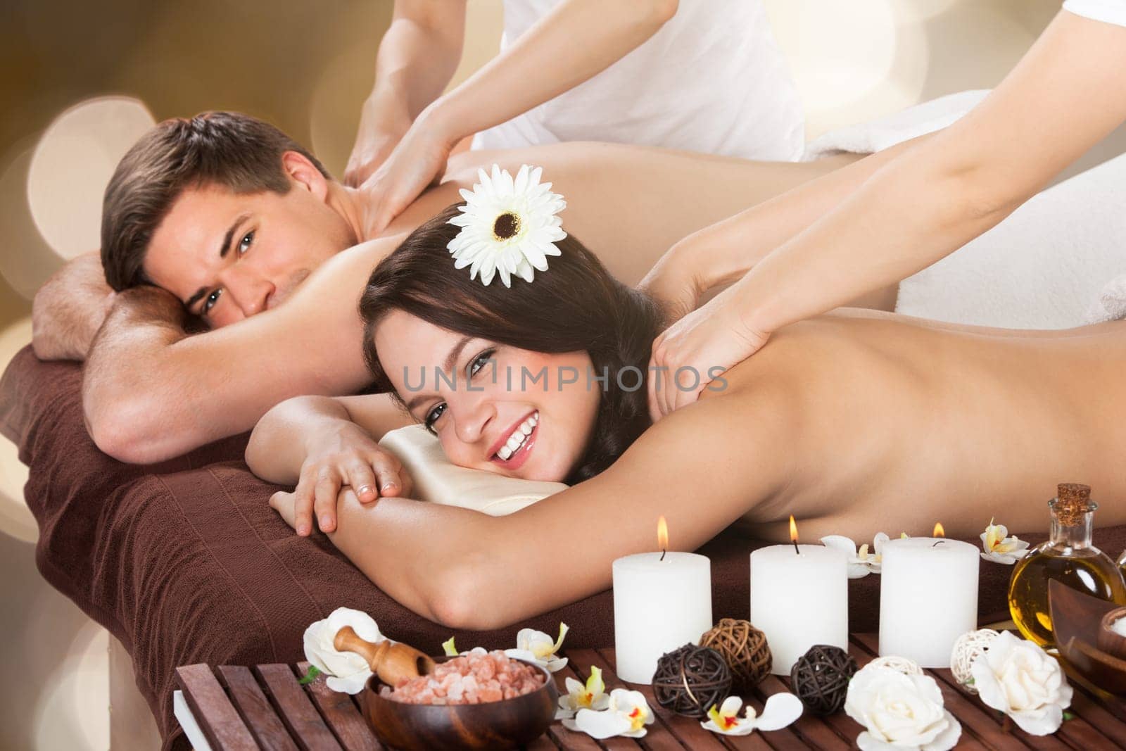 Close-up Of A Young Couple Receiving Shoulder Massage At Beauty Spa