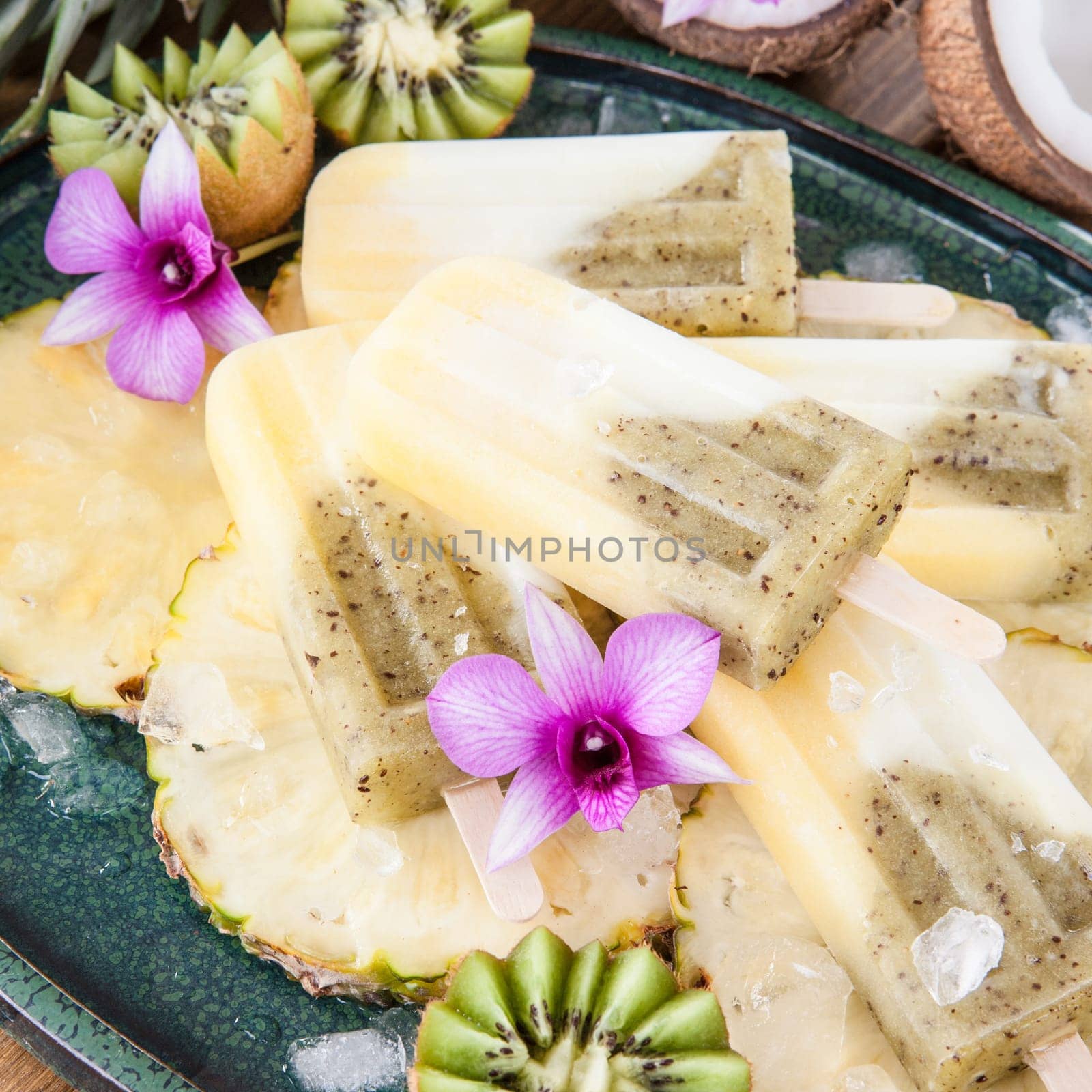 Homemade popsicles with pineapple,coconut and kiwi