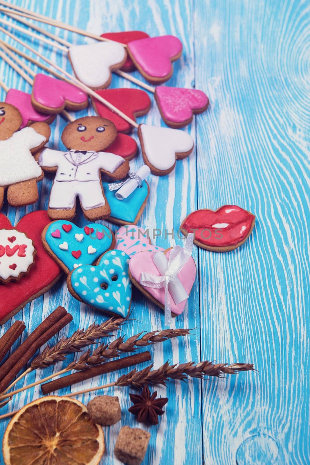 Gingerbreads for Valentines Day or wedding theme on blue wooden background