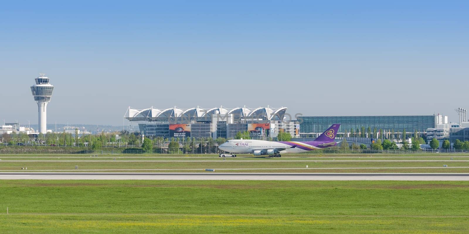 Munich, Germany - May 6, 2016: Passenger turbojet airliner Boeing 747-400 of Thai Airways International airlines taxiing on pushback tug in Munich international airport