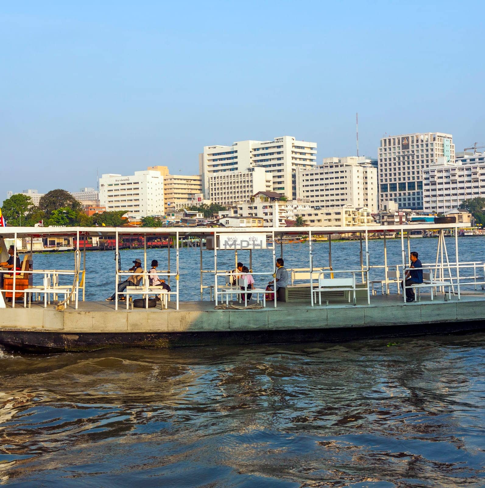 Bangkok, January 4, 2010: people in the boat at the river Mae Nam Chao Phraya in Bangkok, Thailand. Boat ferry is a regular public service on the river.  More than 15 boat lines operate on the river including commuter lines.