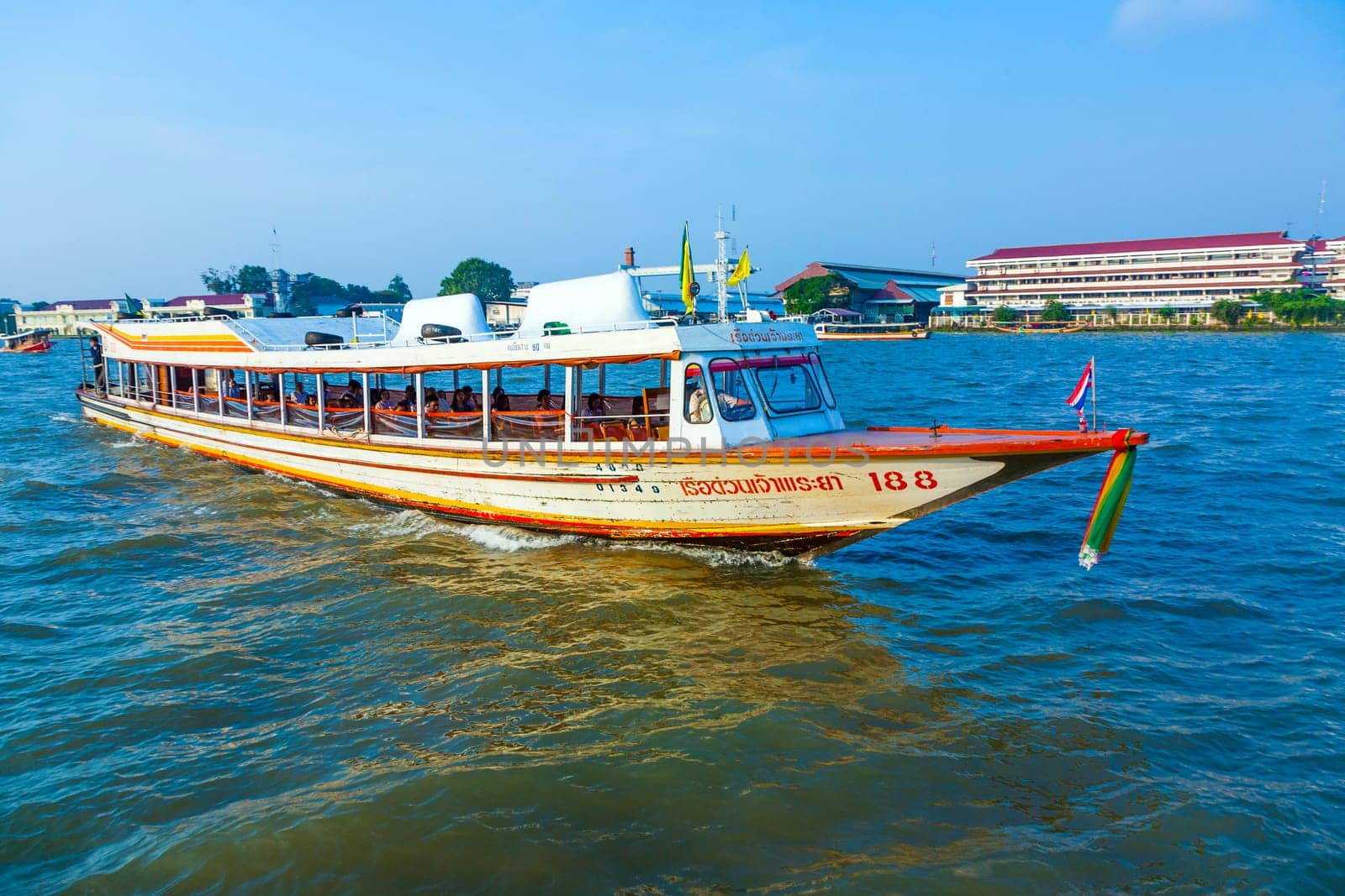 Bangkok, January 4, 2010: people in the boat at the river Mae Nam Chao Phraya in Bangkok, Thailand. Boat ferry is a regular public service on the river.  More than 15 boat lines operate on the river including commuter lines.
