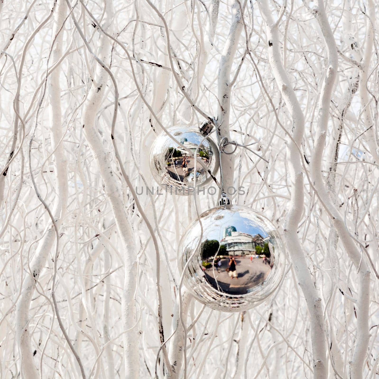 white painted branches give a harmonic background with chrismas tree balls and mirroring