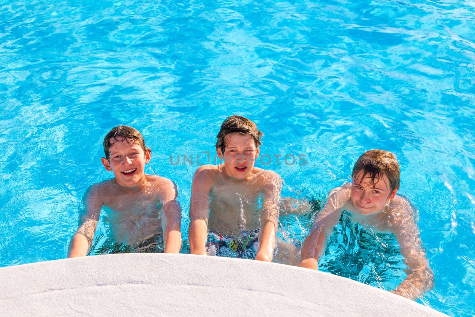 cute boys have fun in the pool