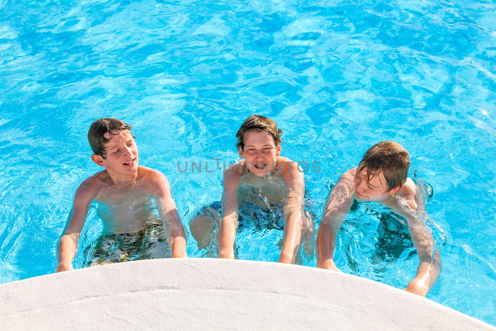 cute boys have fun in the pool