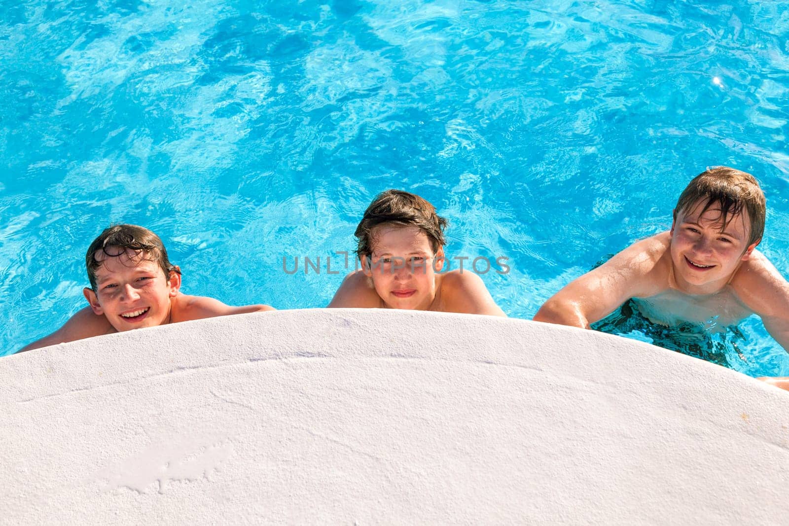 cute boys have fun in the pool