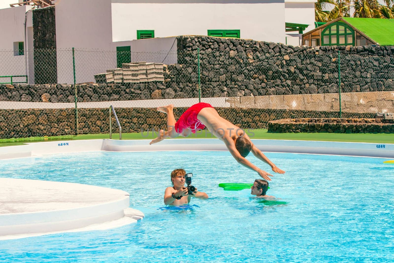 young photographer takes pictures at the pool