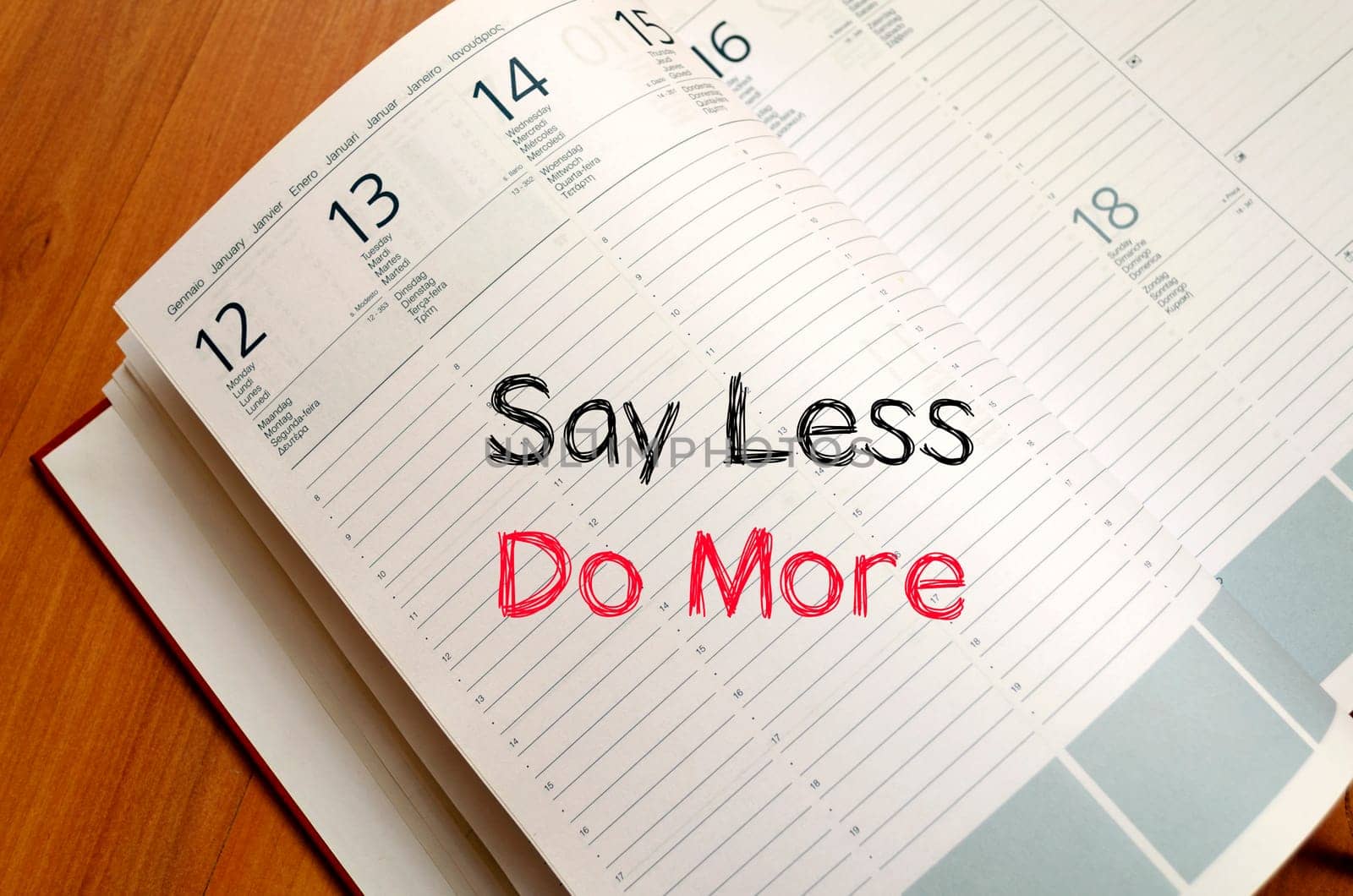 Say less do more text concept write on notebook