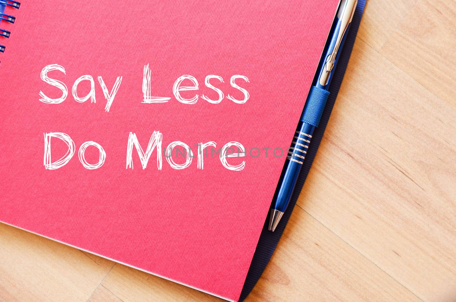 Say less do more text concept write on notebook