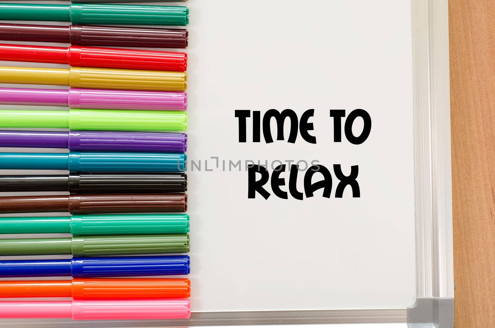 Felt-tip pen and whiteboard on a wooden background and text concept
