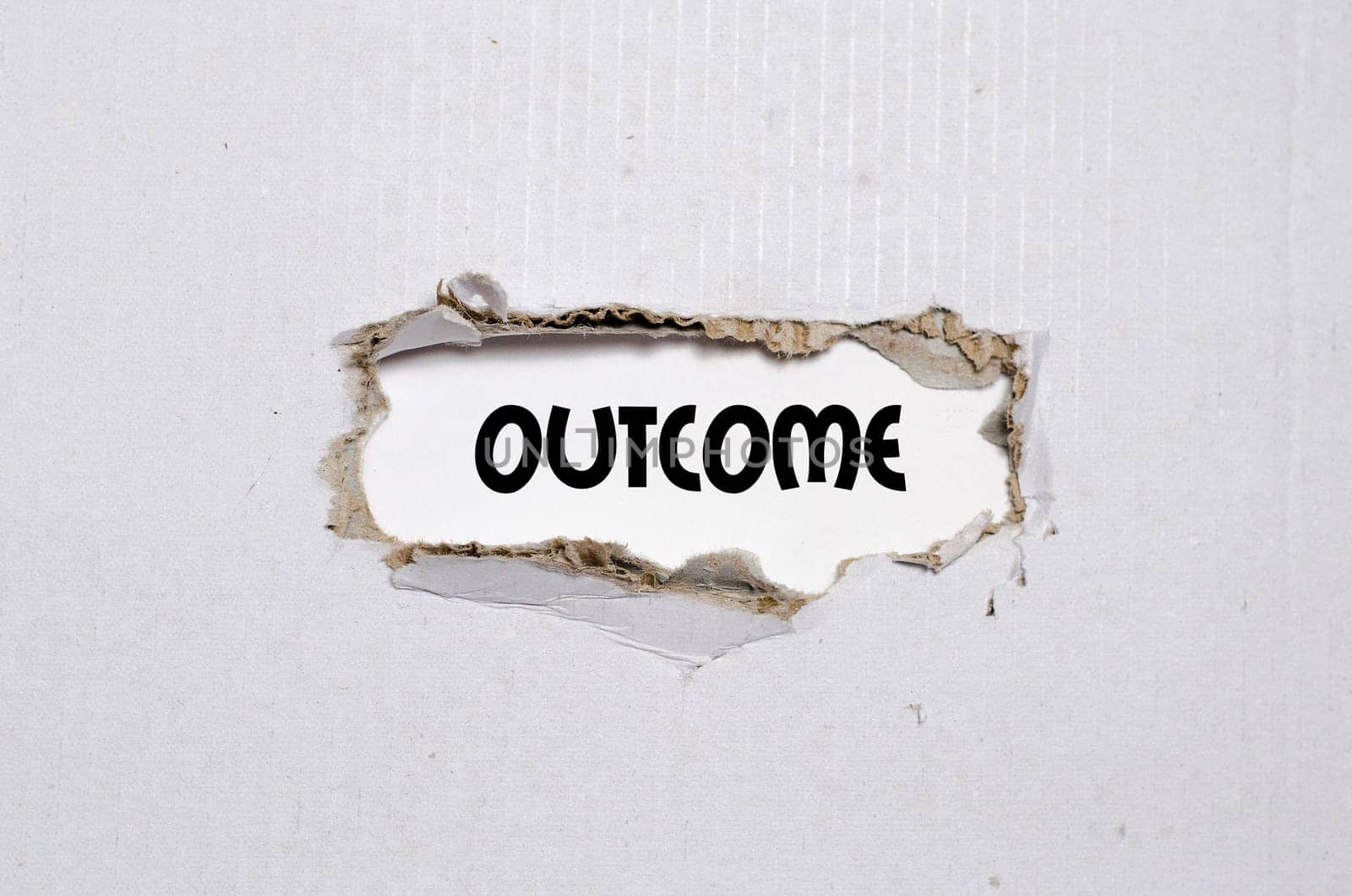 The word outcome appearing behind torn paper