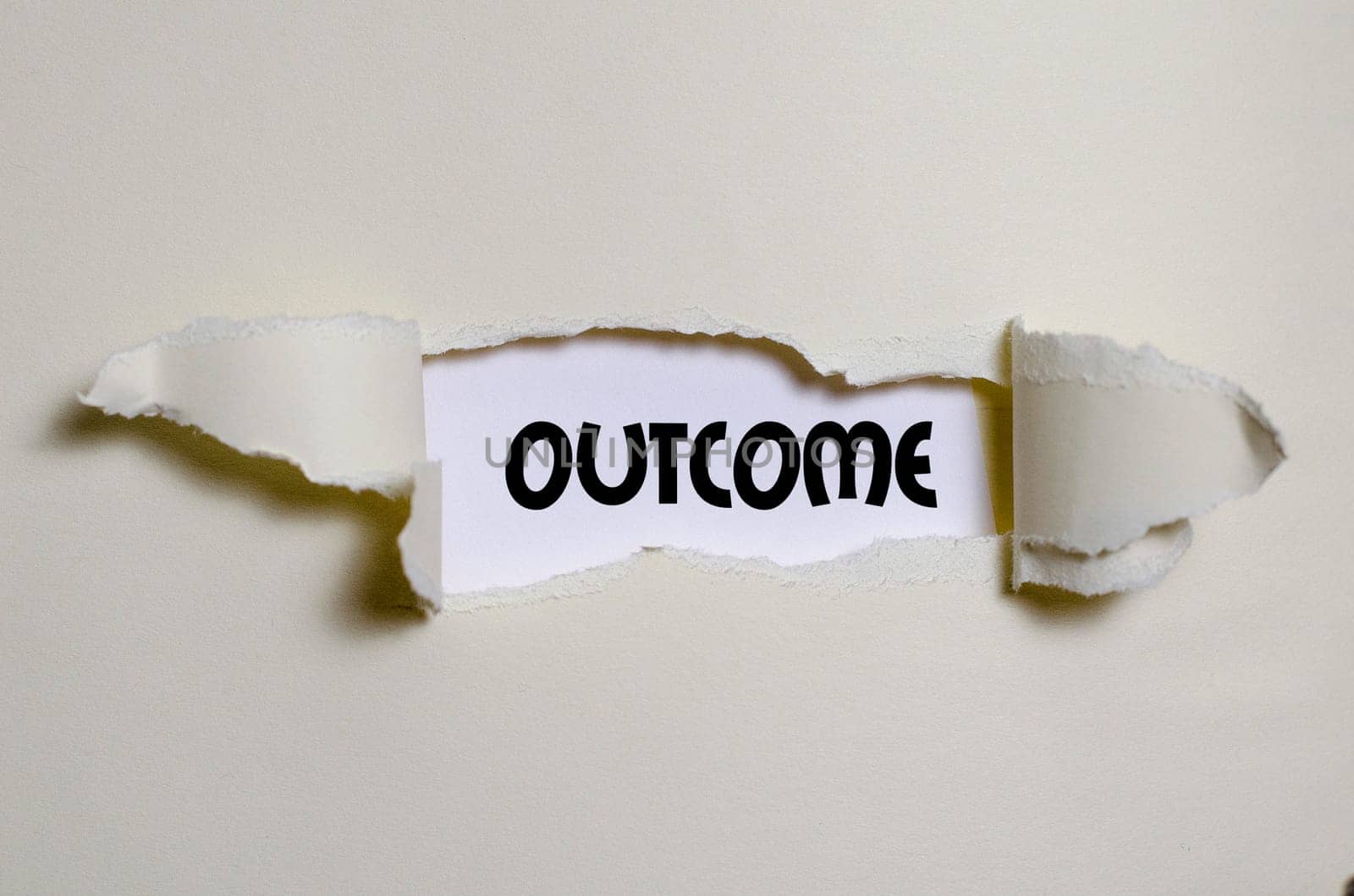 The word outcome appearing behind torn paper