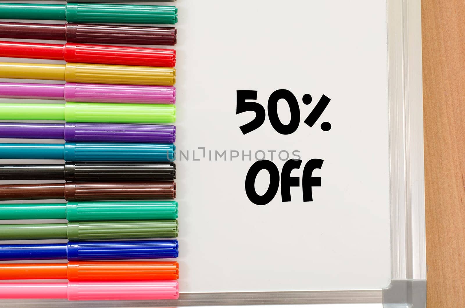 Felt-tip pen and whiteboard on a wooden background and text concept