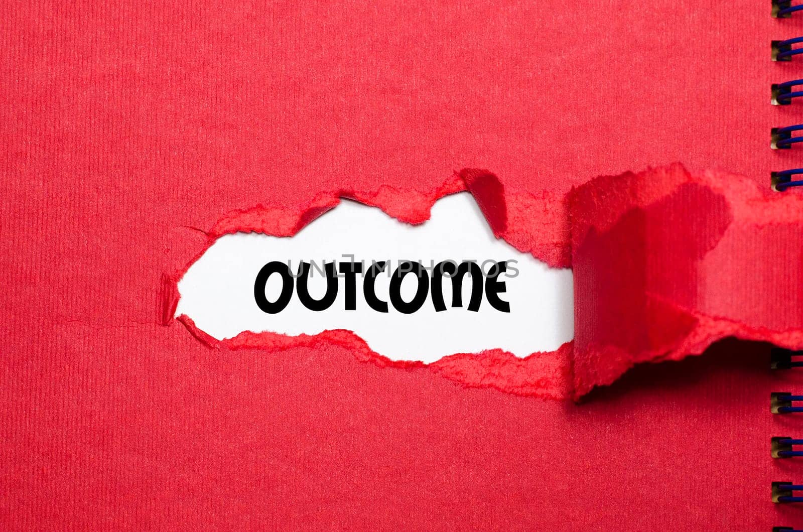 The word outcome appearing behind torn paper