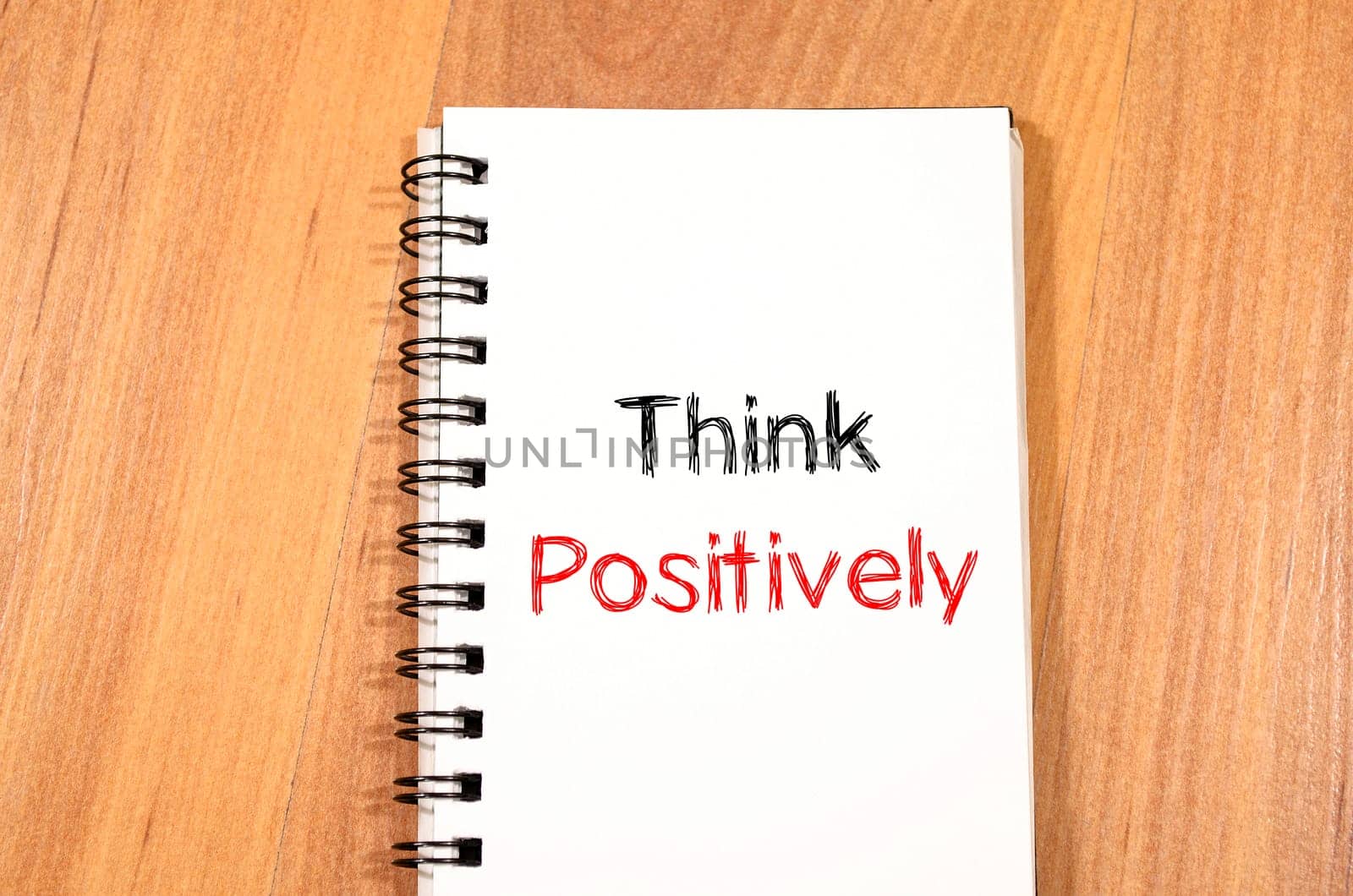 Think positively text concept write on notebook