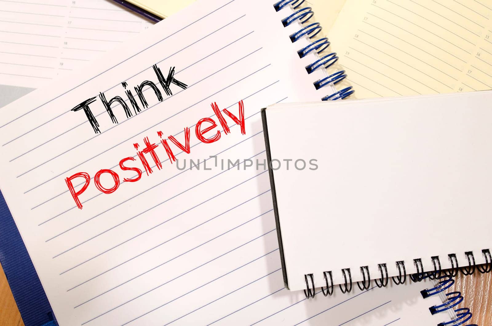Think positively text concept write on notebook