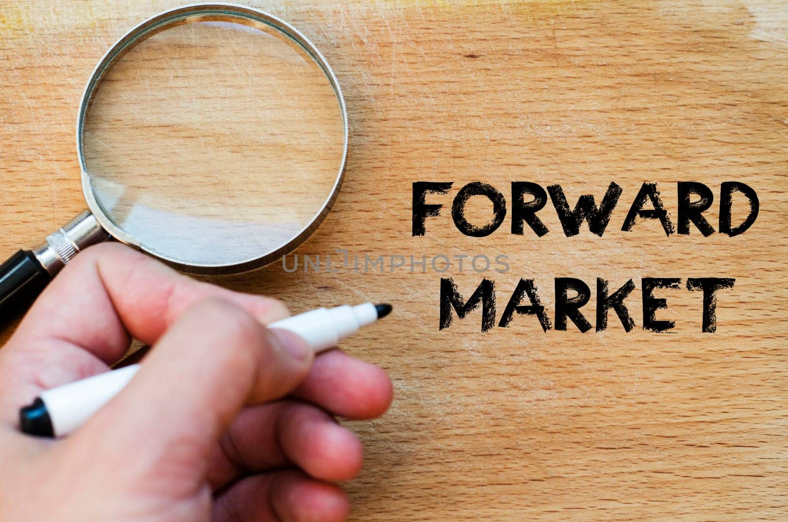Human hand over wooden background and forward market text concept