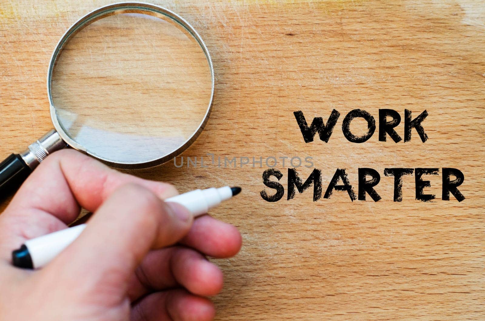 Human hand over wooden background and work smarter text concept