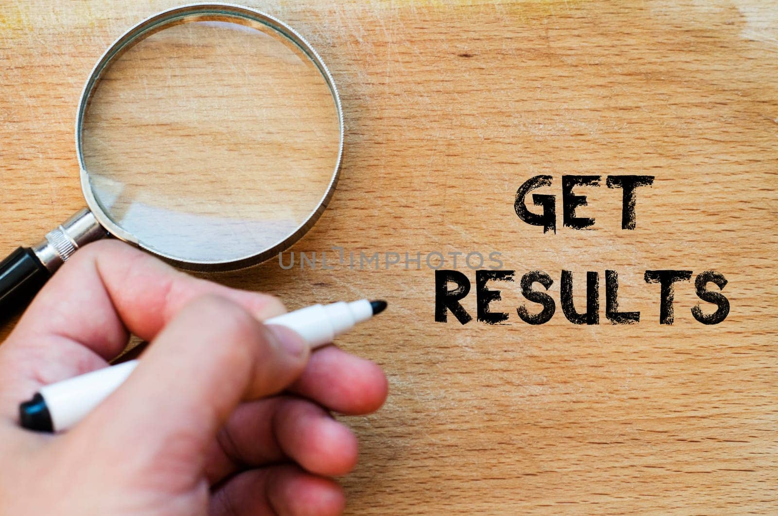 Human hand over wooden background and get results text concept
