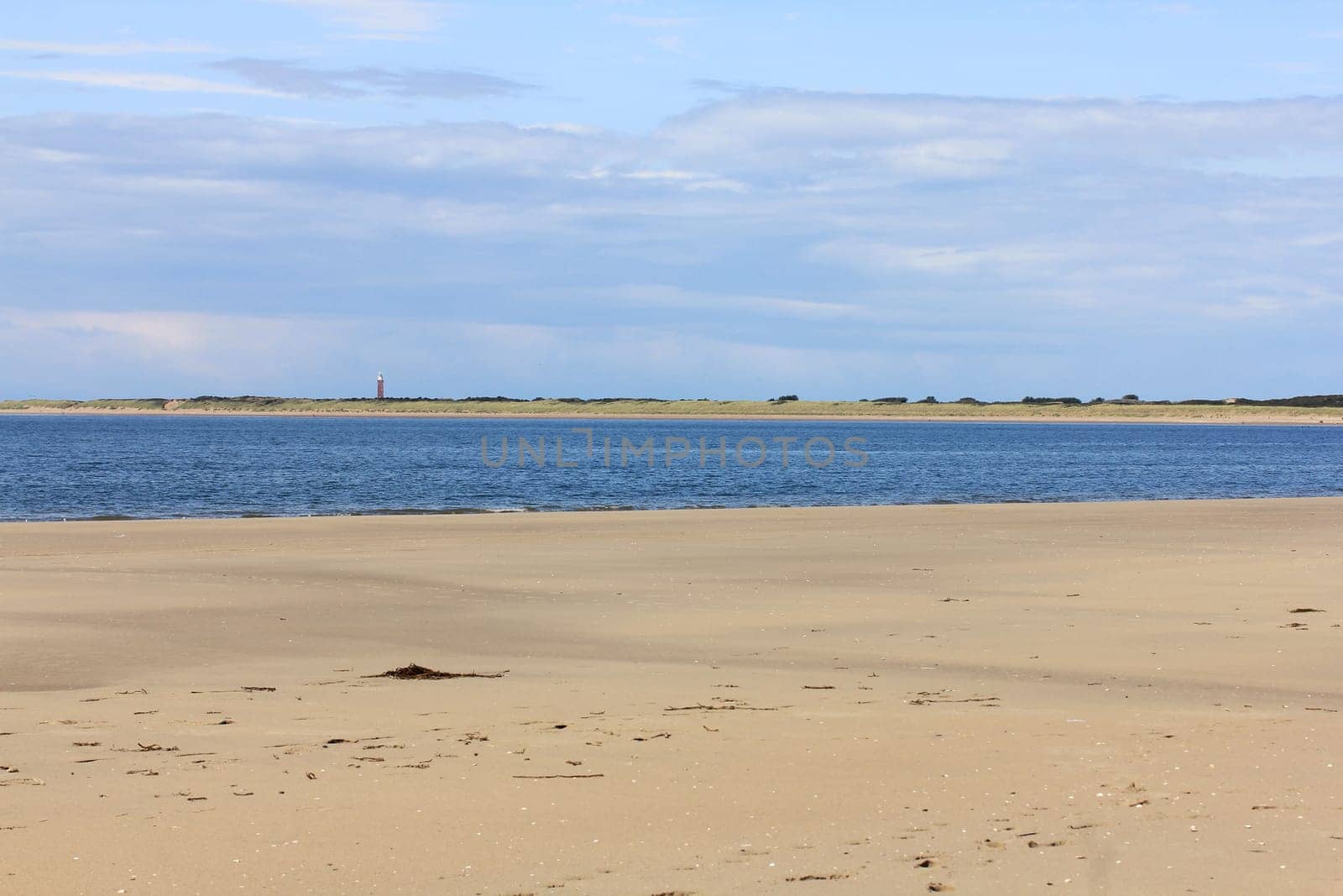 Lonely sandy beach,with blue sky and few clouds.