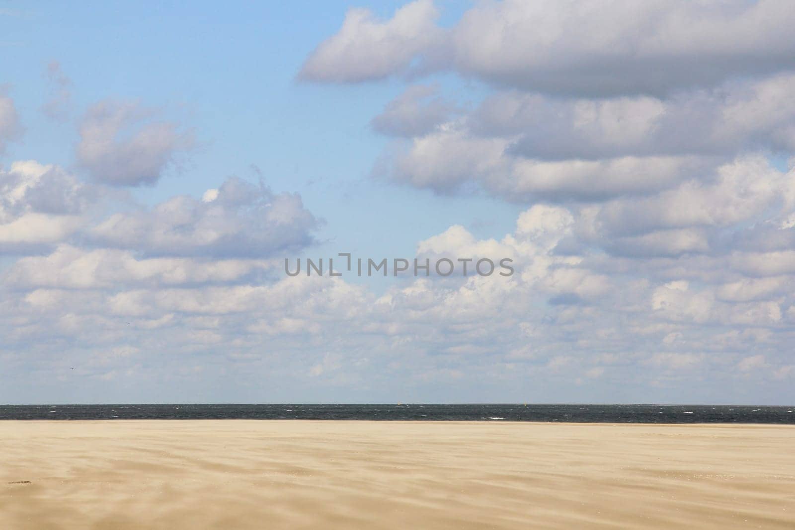 Lonely sandy beach,with blue sky and few clouds.