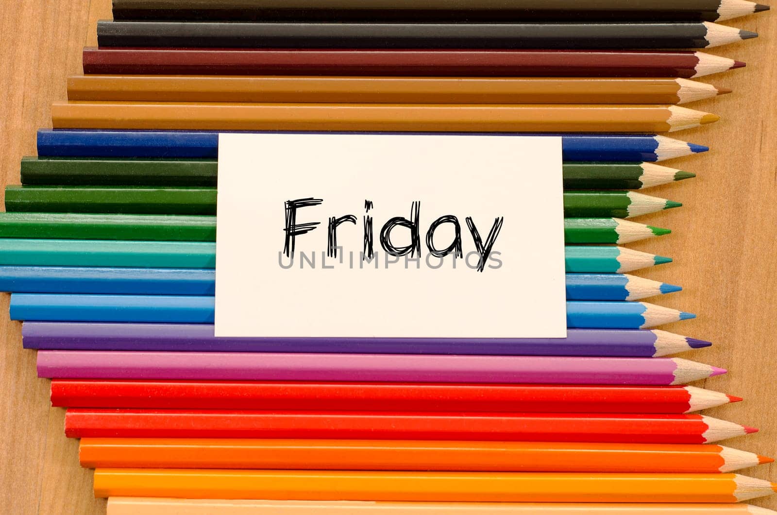 Blank white paper and colored pencils on wooden background