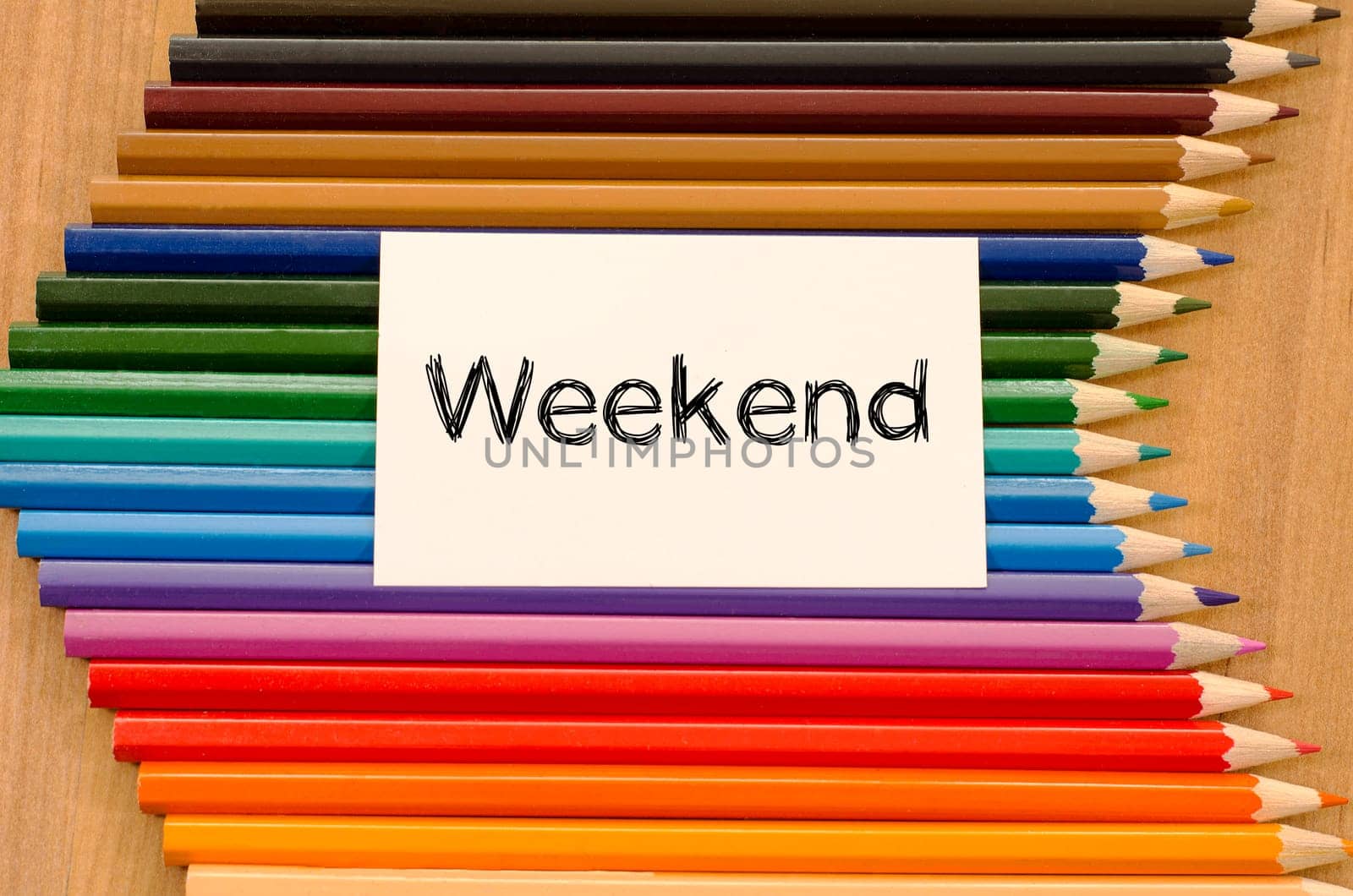 Blank white paper and colored pencils on wooden background