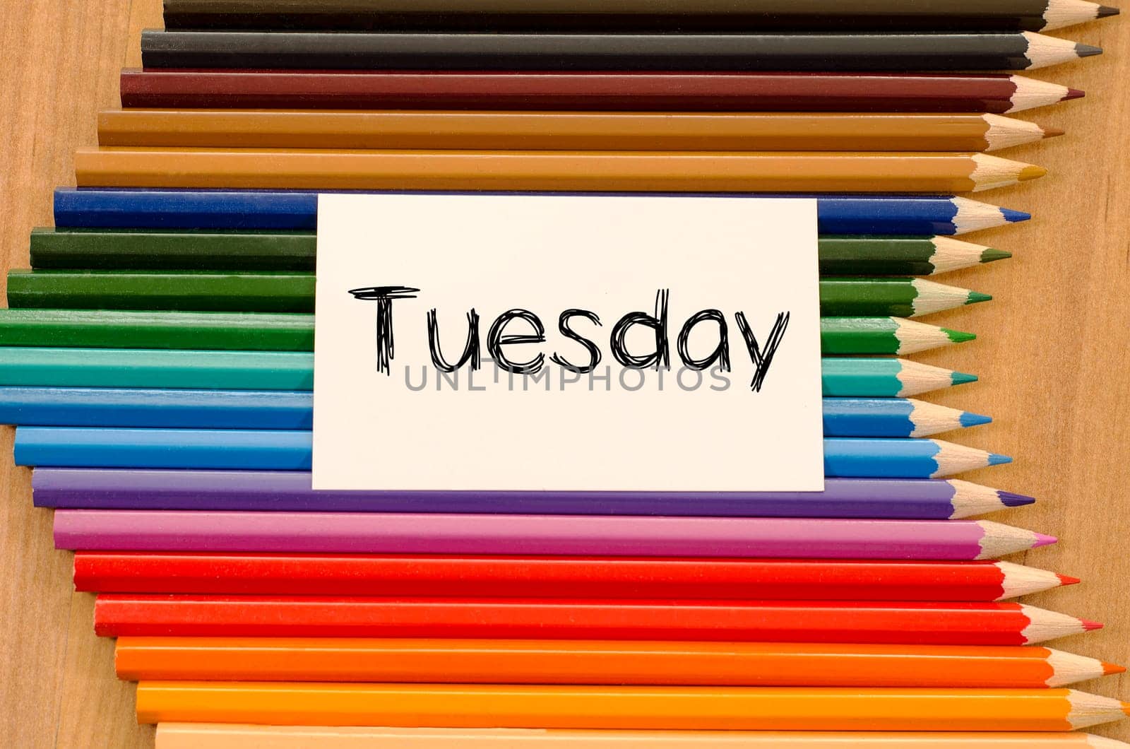 Blank white paper and colored pencils on wooden background