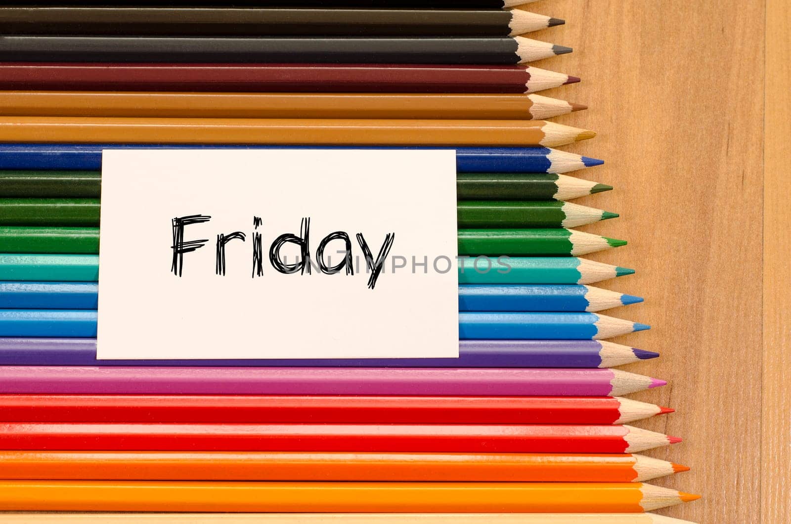 Blank white paper and colored pencils on wooden background