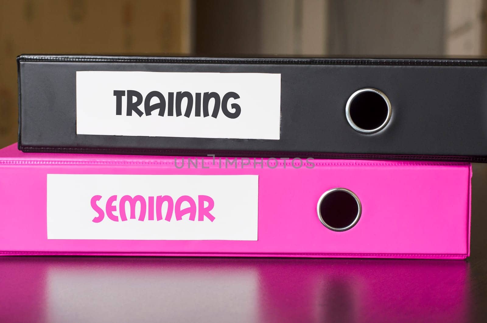 Bright office folders over dark background and training and seminar text concept
