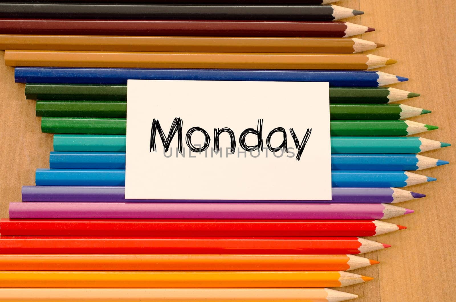 Blank white paper and colored pencils on wooden background