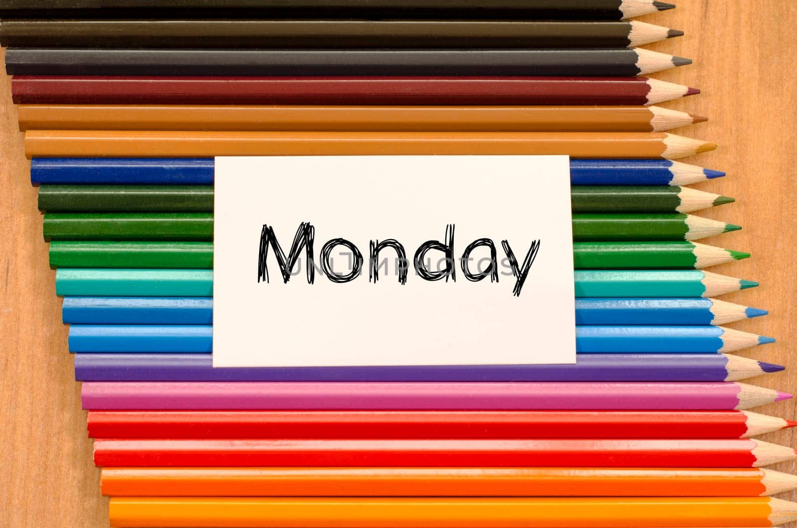 Blank white paper and colored pencils on wooden background