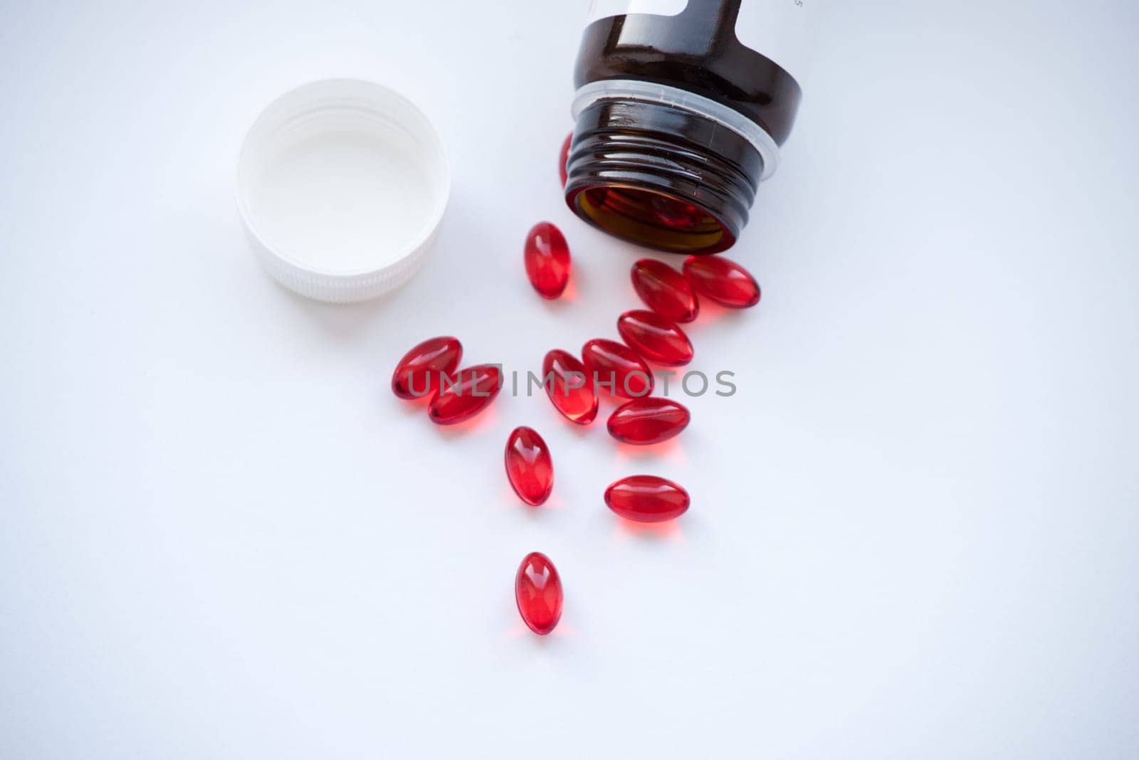 Tabs Vitamins, omega 3, Medications tablets and capsules in a beaker. Medications tablets, suppository bottles, capsules and thermometer on wooden table
