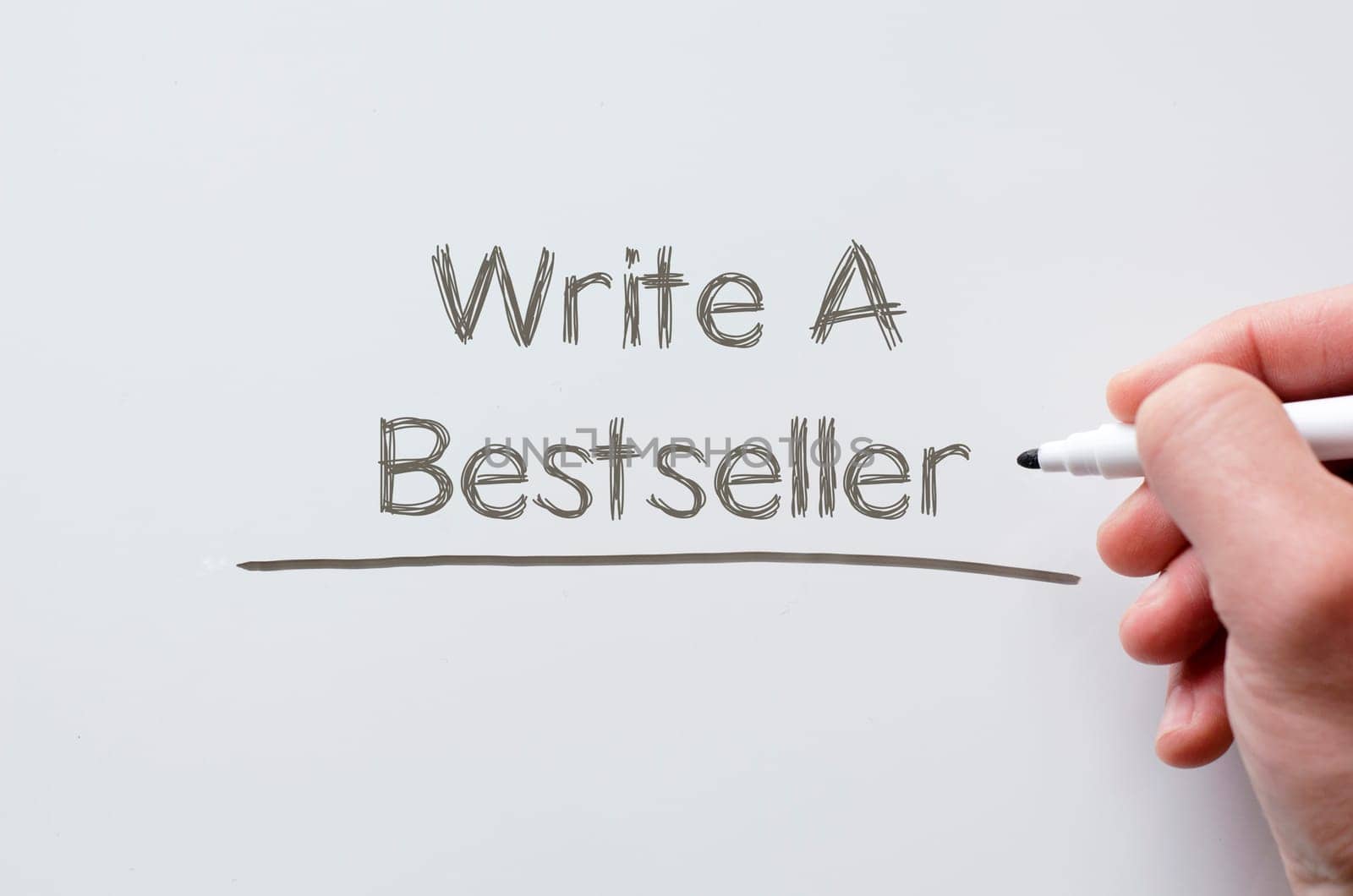 Human hand writing write a bestseller on whiteboard