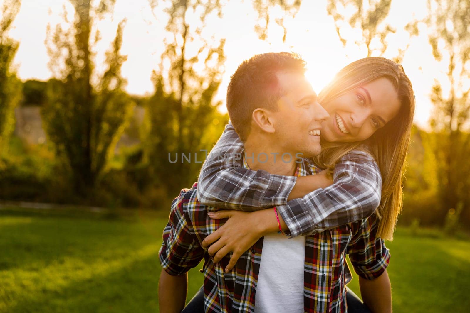 Portrait of a happy young couple in the nature hugged together