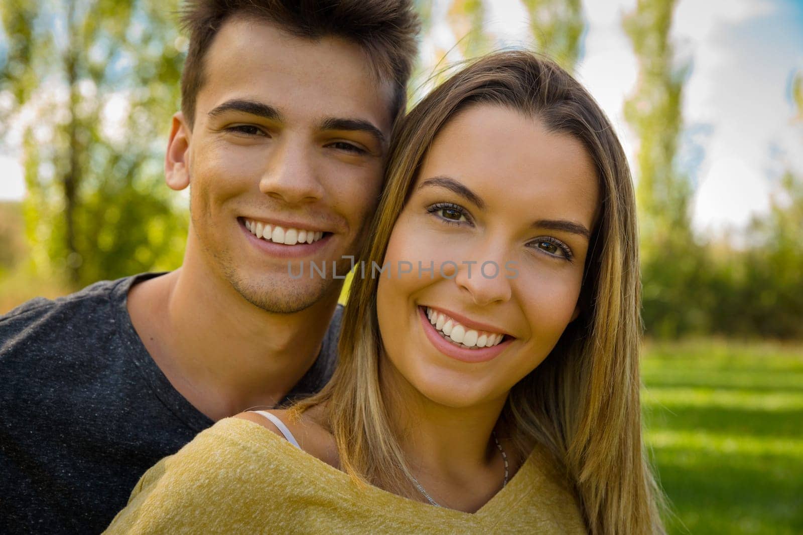 Portrait of a happy young couple embraced together