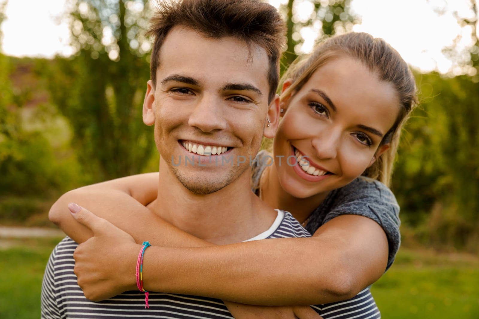 Portrait of a happy young couple embraced together