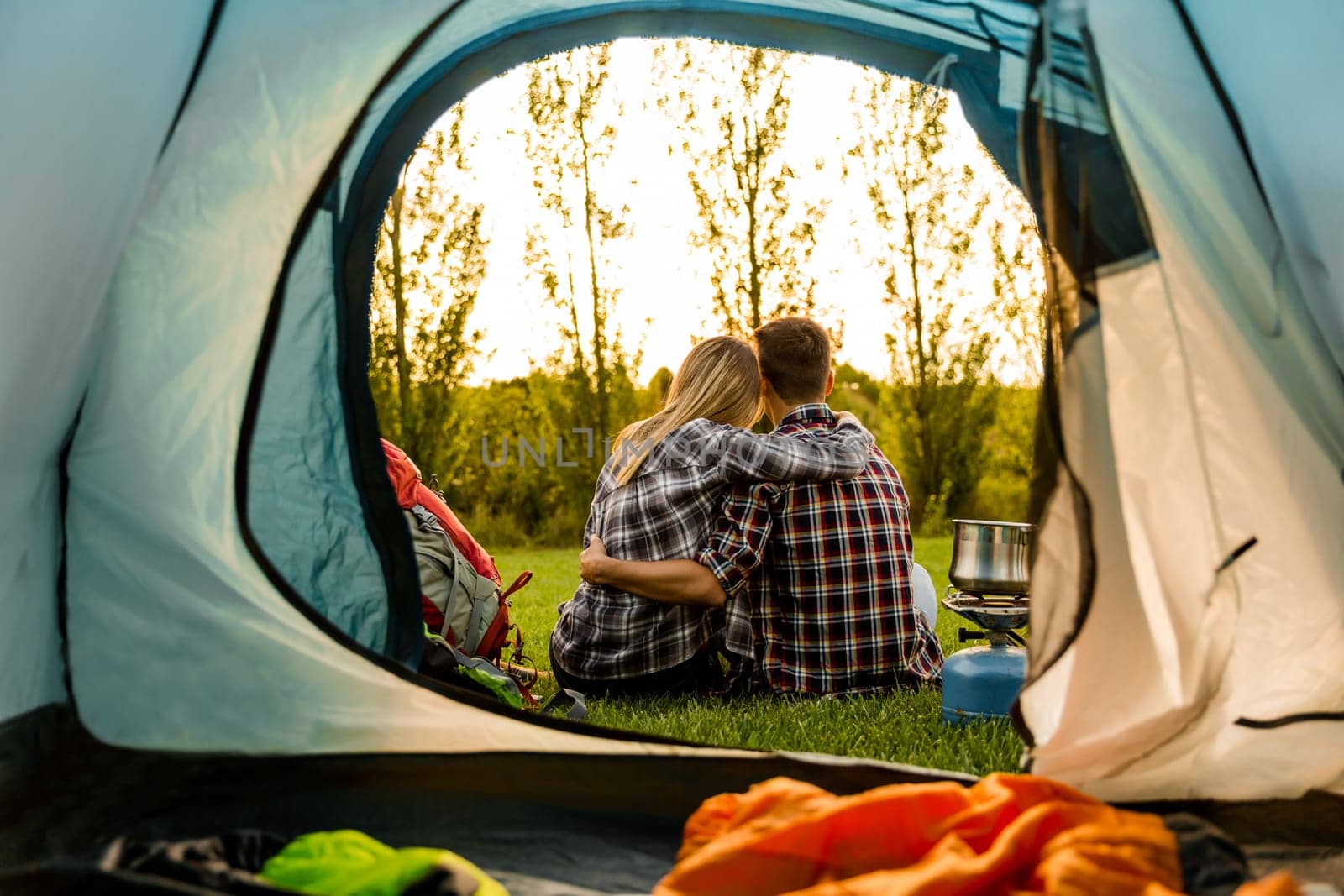 Shot of a happy couple camping on the nature and making a selfie