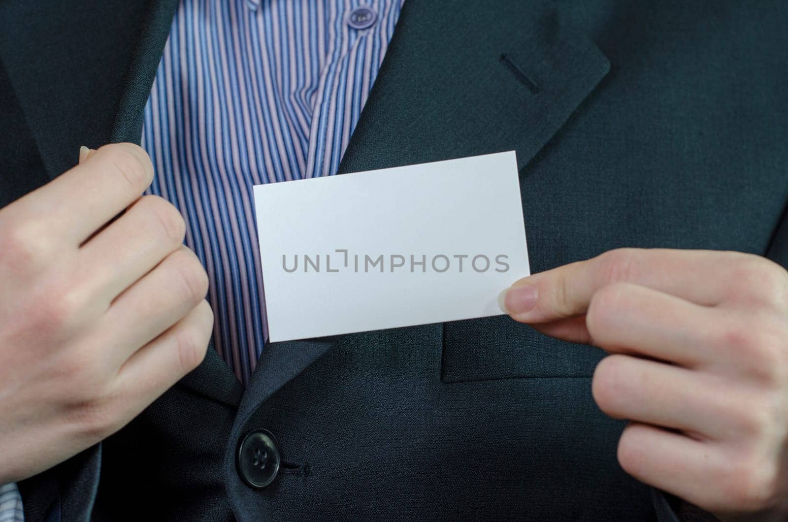 Business woman hand holding white empty note..