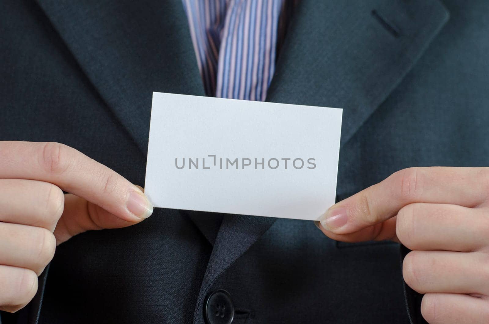 Business woman hand holding white empty note..
