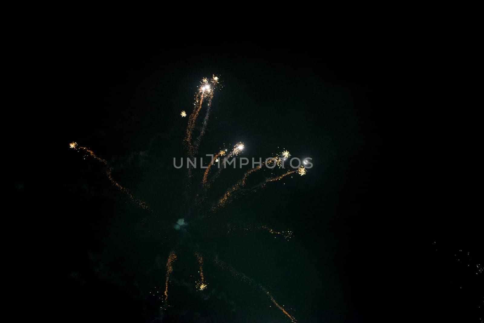 Fireworks on the dark nightly sky with smoke