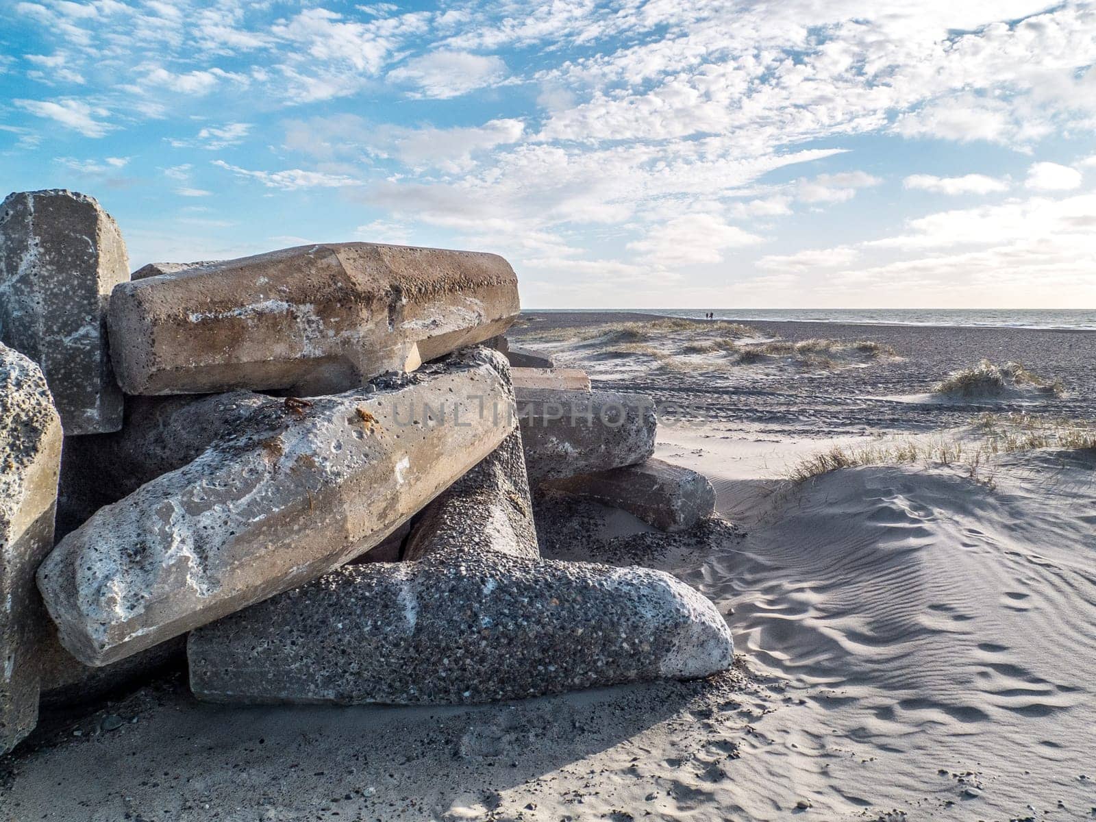 beach with concrete pillars that serve as coastal protection against flooding and sand erosion in storm