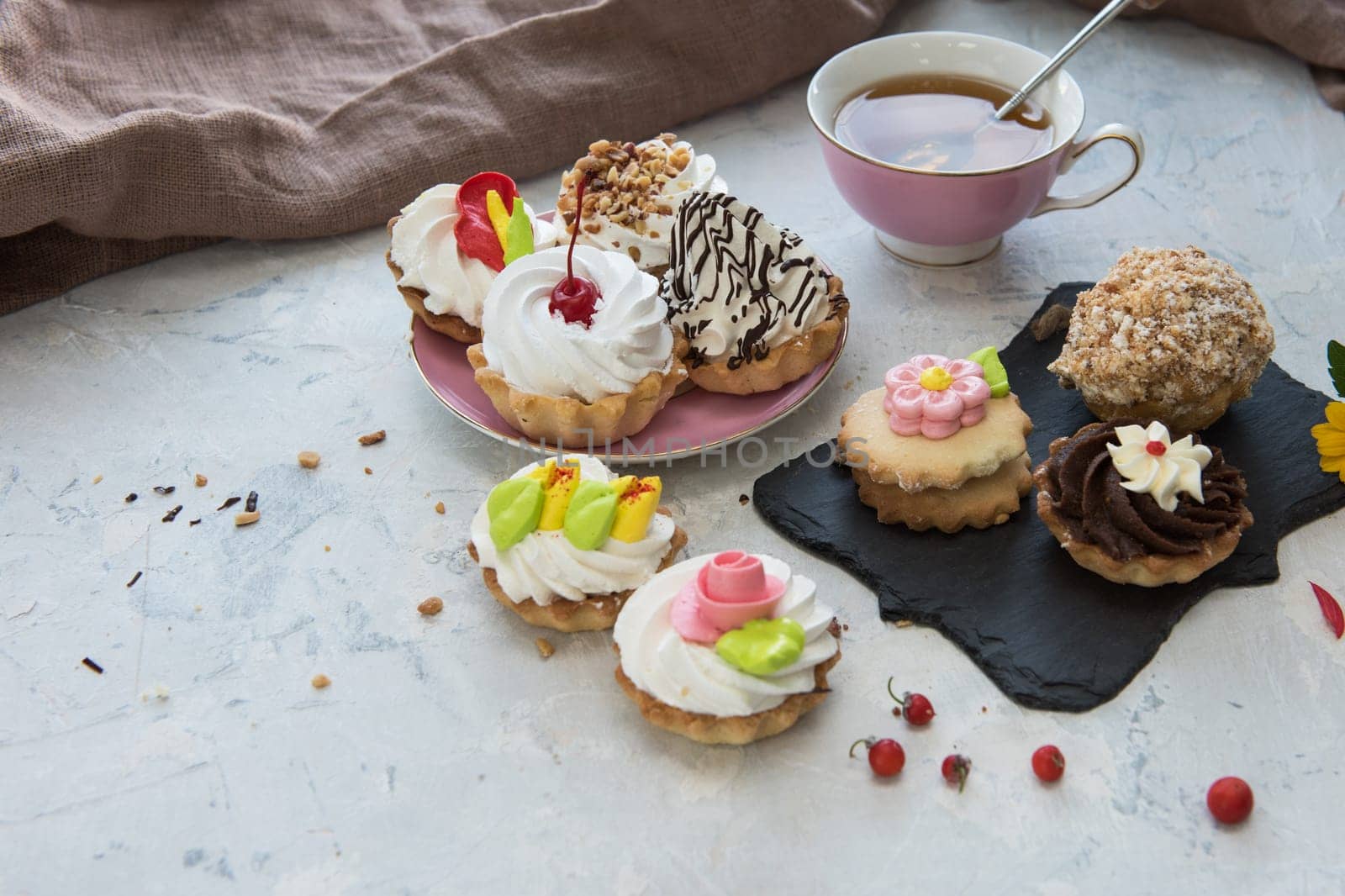 Different cakes composition on concrete background
