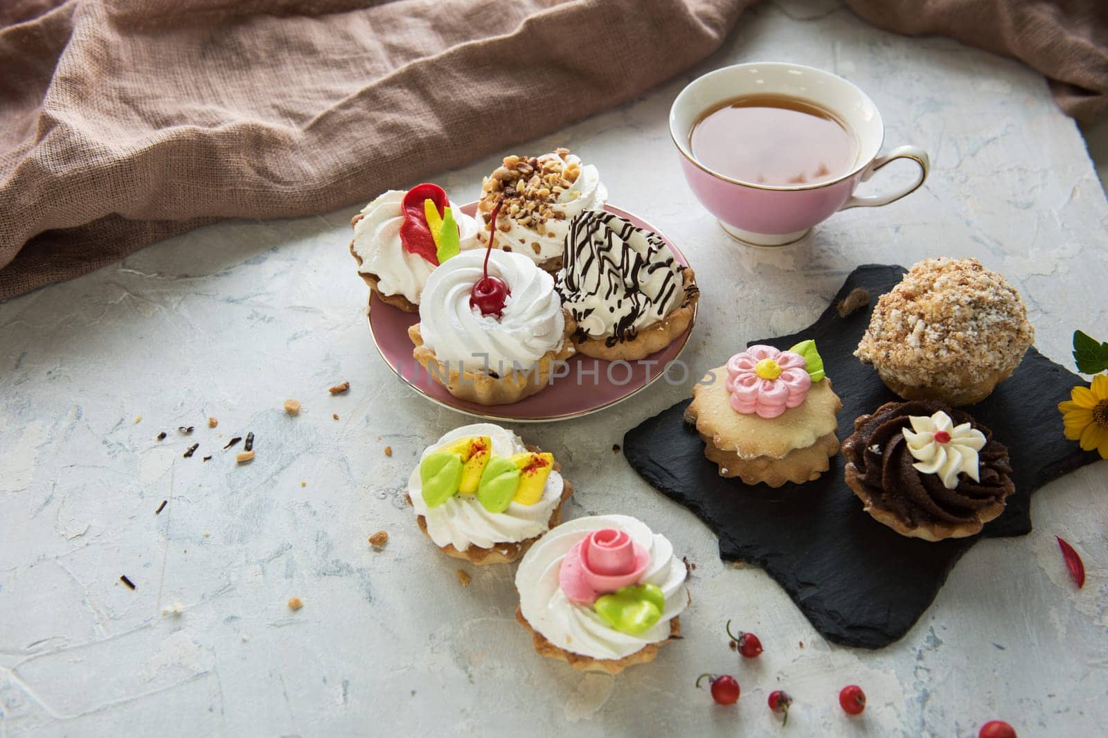 Different cakes composition on concrete background