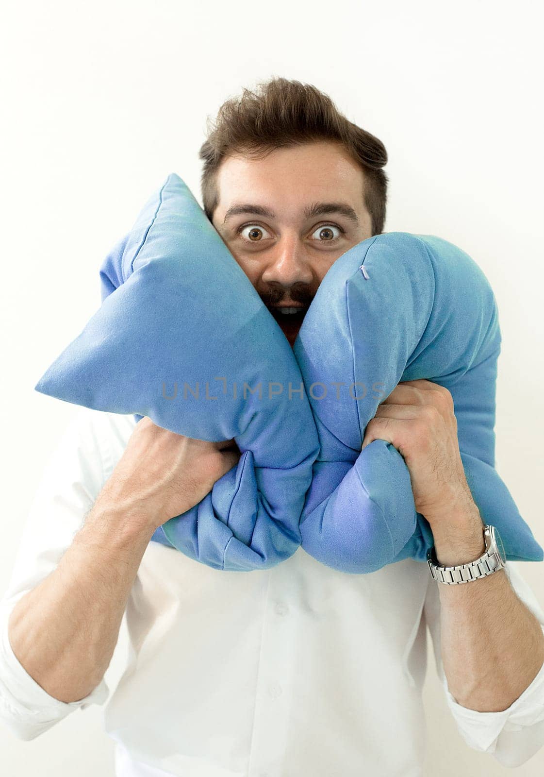 Crzy shocked surprised man with pillows