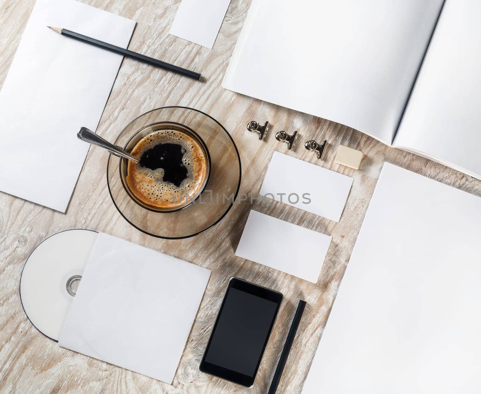 Photo of blank stationery set on light wooden table background. Corporate identity template. Blank objects for placing your design. Branding ID mockup. Top view.